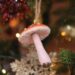 Christmas decoration in form of mushroom hangs on the Christmas tree, close-up.